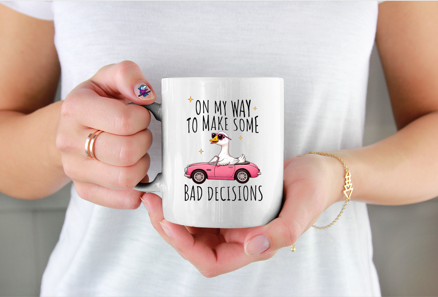 Person holding a mug with a humorous design and text on my way to make bad decisions with photo of a goose
