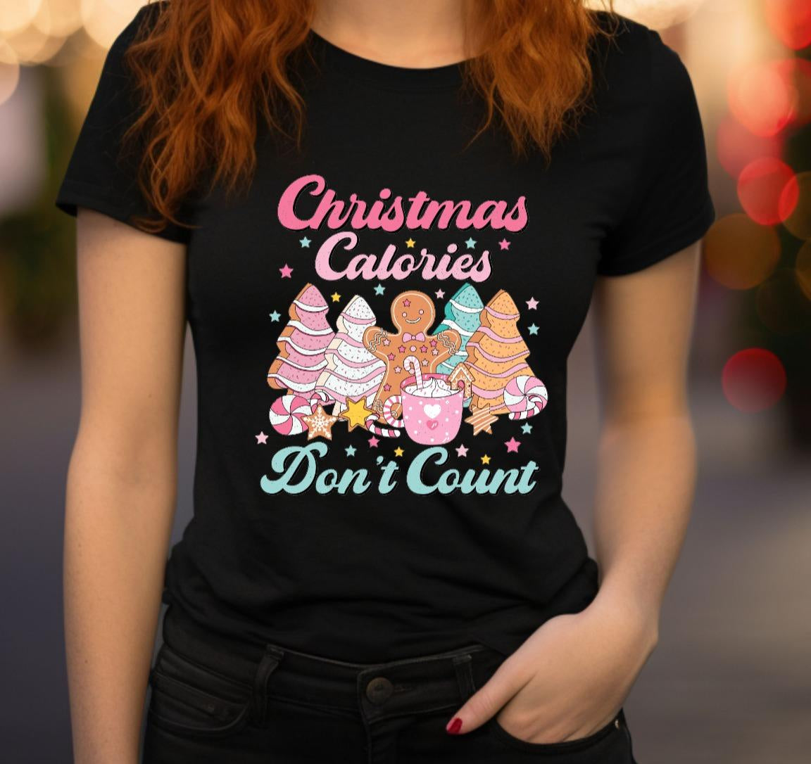 Person wearing a black t-shirt with Christmas-themed graphics and text.