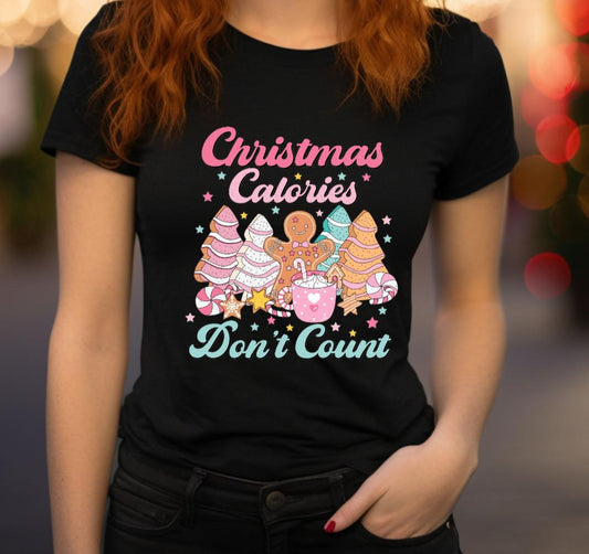 Person wearing a black t-shirt with Christmas-themed graphics and text.