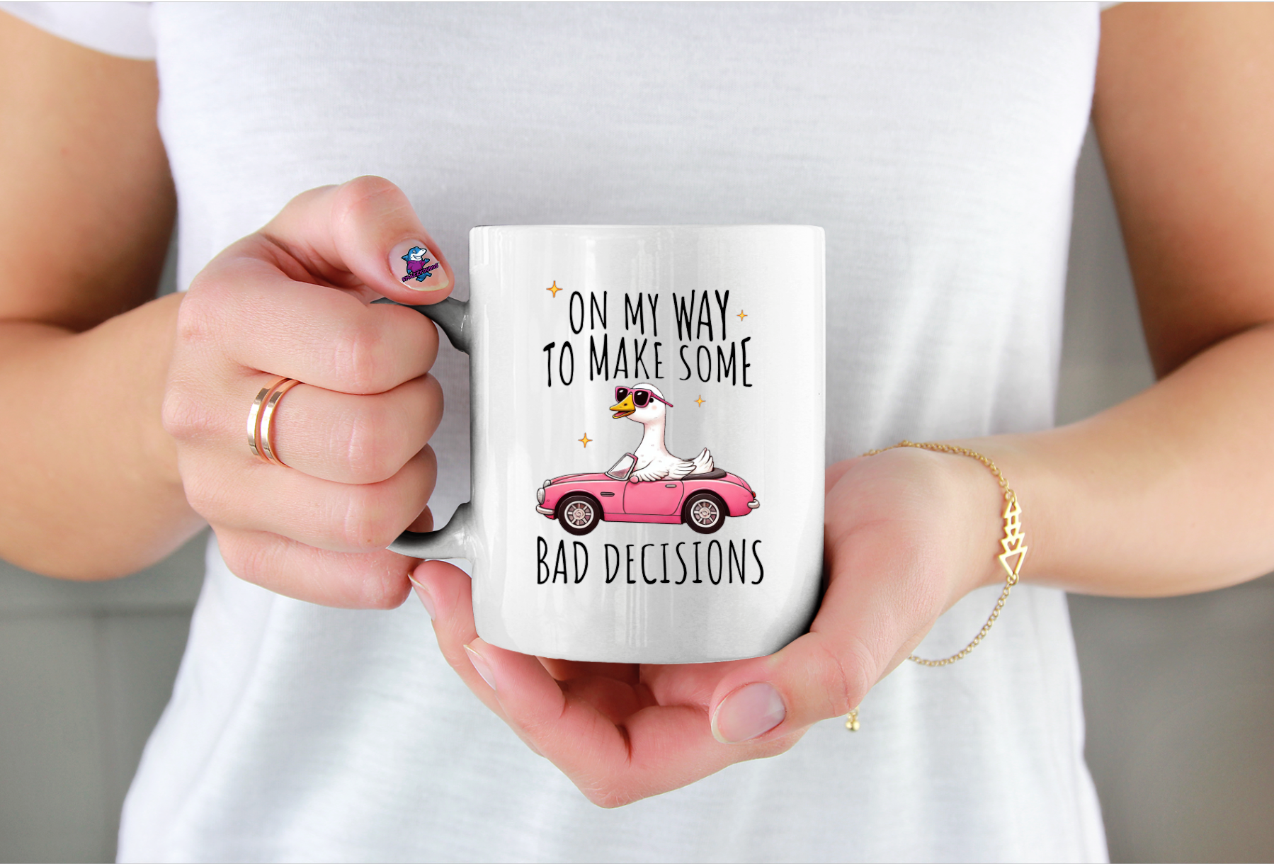 Person holding a mug with a humorous design and text on my way to make bad decisions with photo of a goose