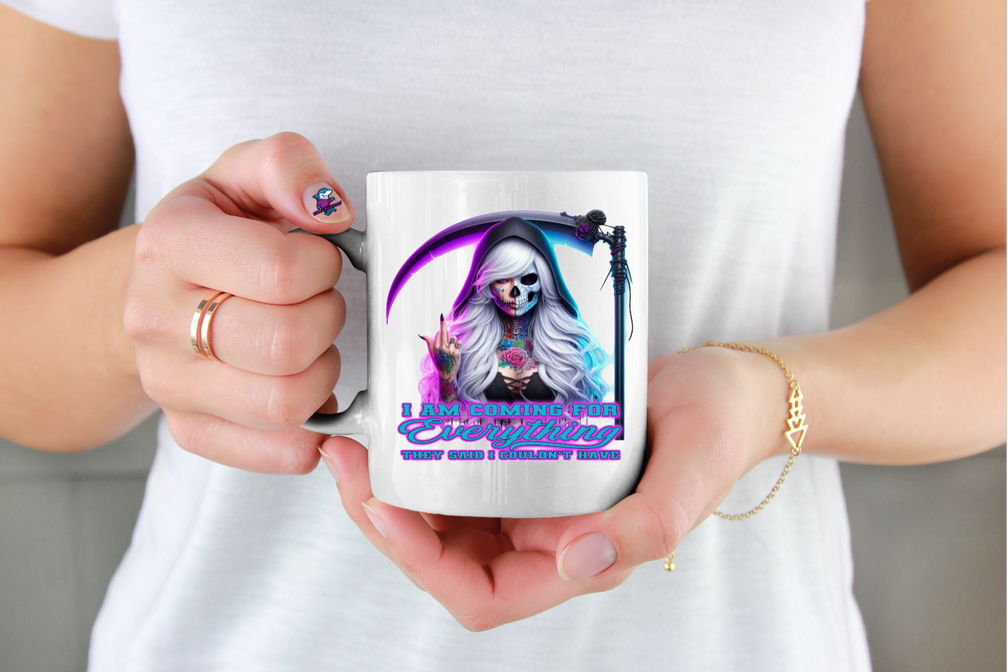 Person holding a mug with a colorful design of a skeleton 