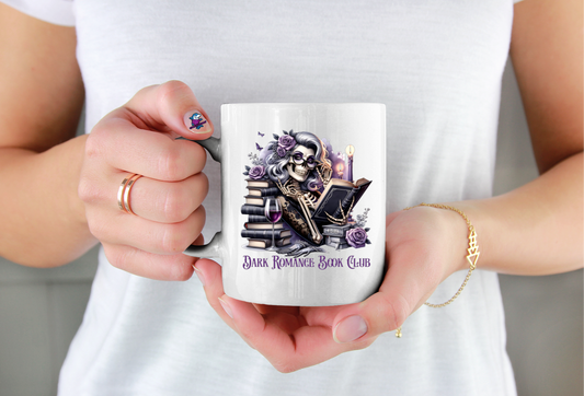 Person holding a mug with a skull and books design and 'Dark Romance Book Club' text.