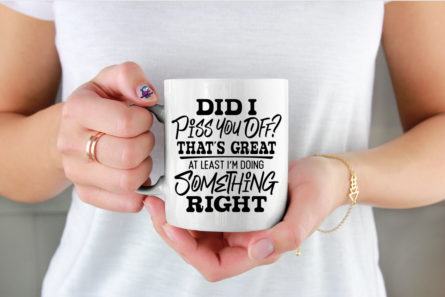 Person holding a white mug with humorous text design.