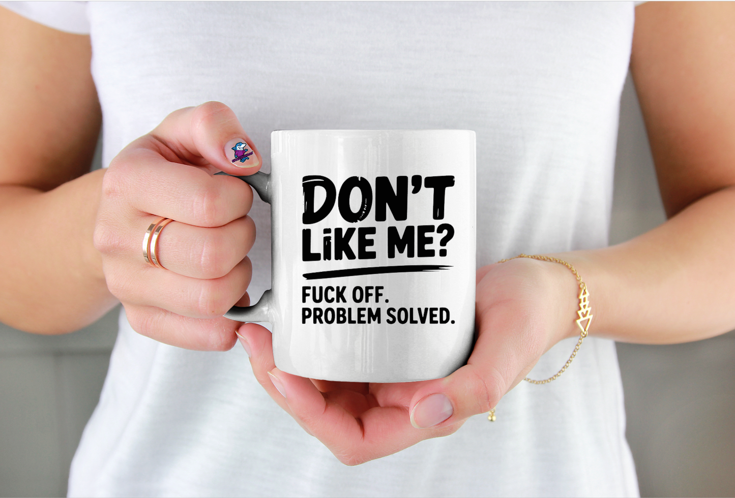 Person holding a mug with text design