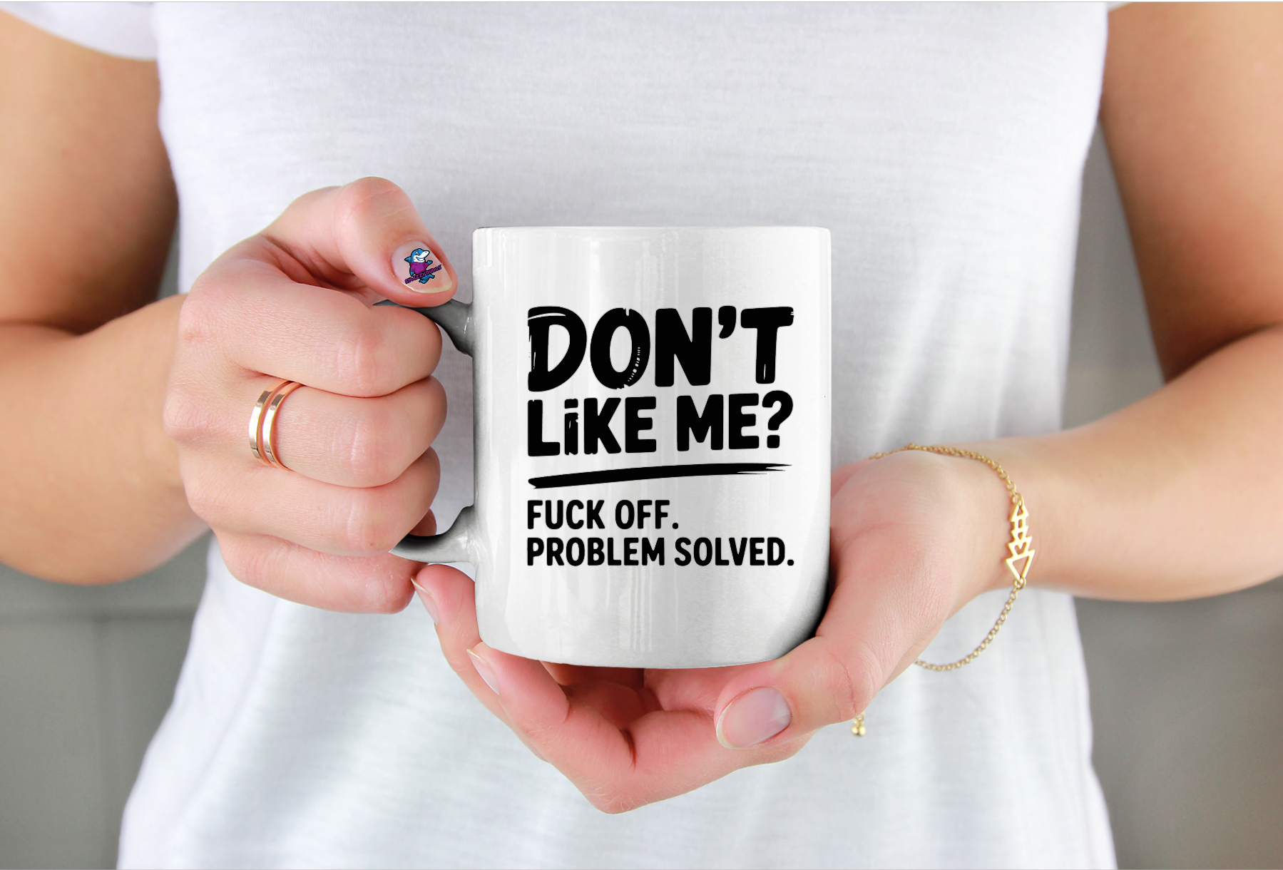 Person holding a mug with text design