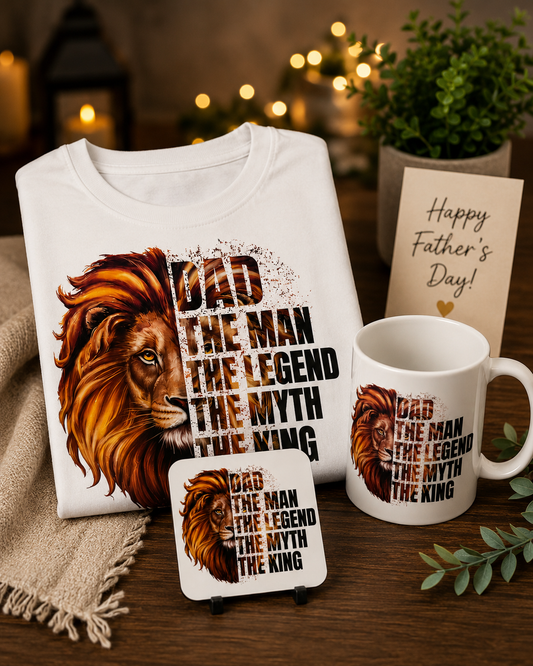 White t-shirt, mug, and coaster with lion design and 'Dad The Man The Legend The Myth The King' text on a wooden surface. Fathers Day Gift Set