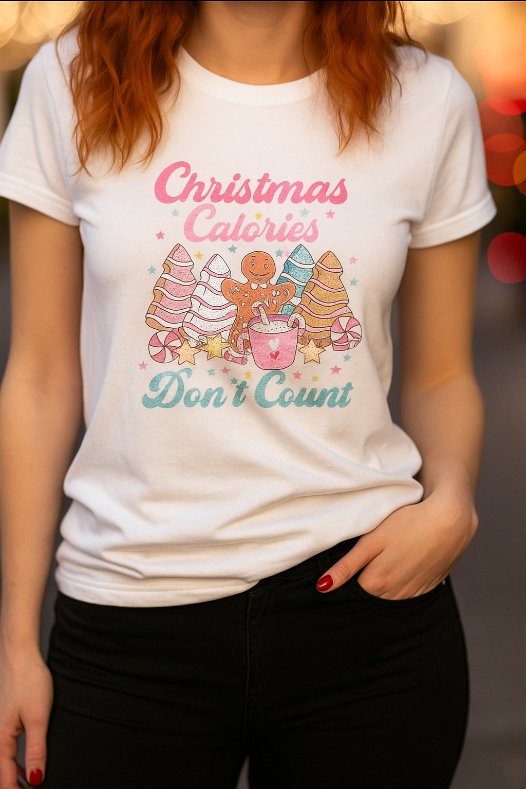 Person wearing a white t-shirt with Christmas-themed graphics and text.