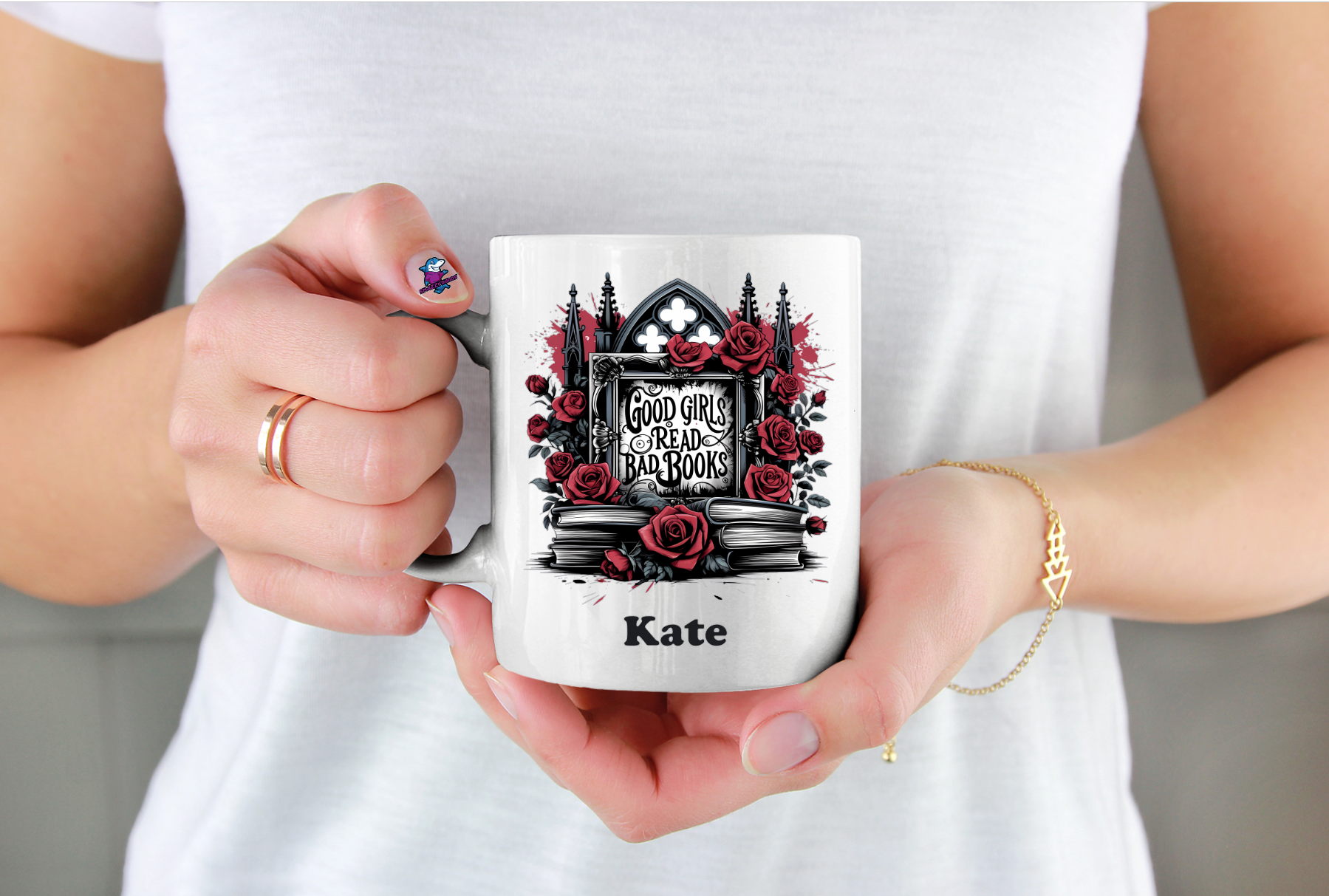 Person holding a mug with a design of roses and a cathedral, and the name 'Kate' on it.