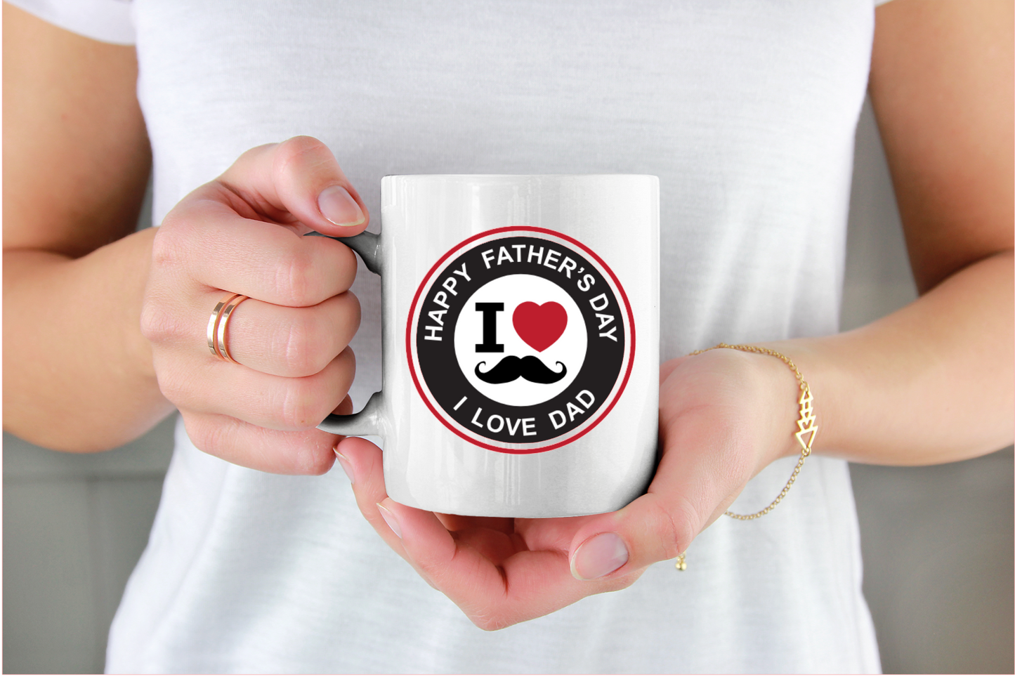 Person holding a mug with a 'Happy Father's Day, I Love Dad' design.