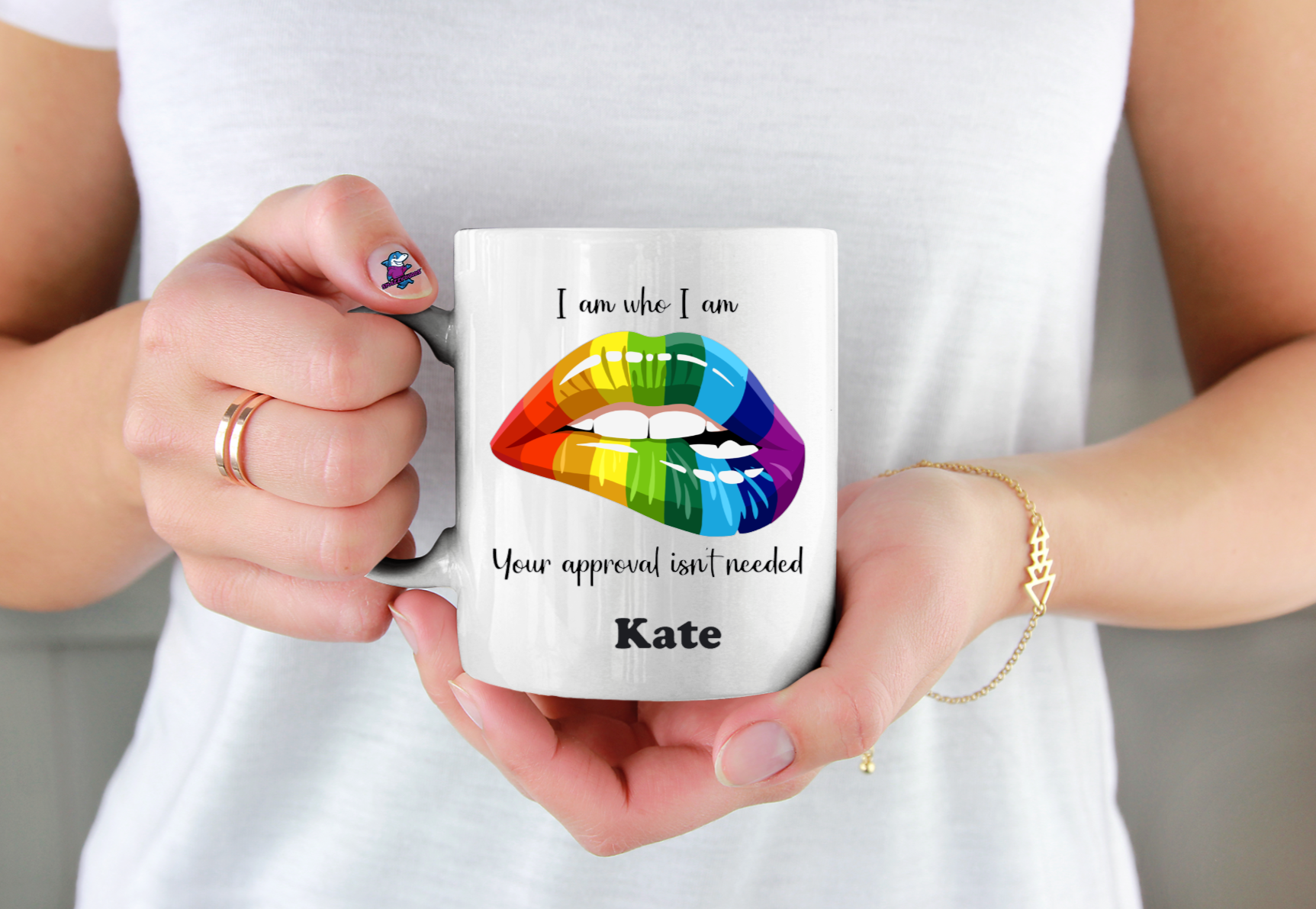 Person holding a mug with rainbow lips design and text