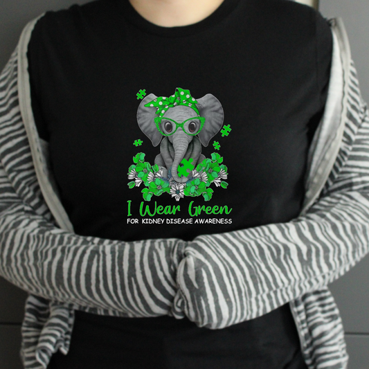 Person wearing a black tshirt with a elephant design and text for kidney disease awareness