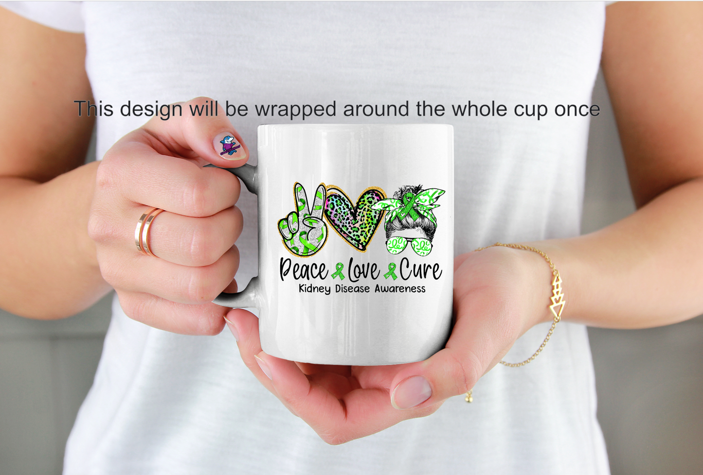 Person holding a white mug with 'Peace Love Cure' design, featuring a images and text kidney disease awareness
