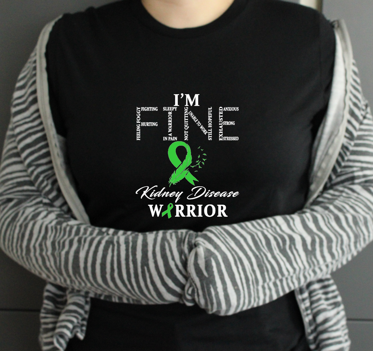 Person wearing a black tshirt with a kidney disease warrior design.