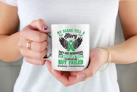 Person holding a mug with a green ribbon design and text about kidneyawareness.