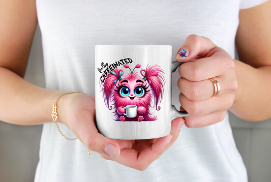 Person holding a mug with a cartoon character and text design.