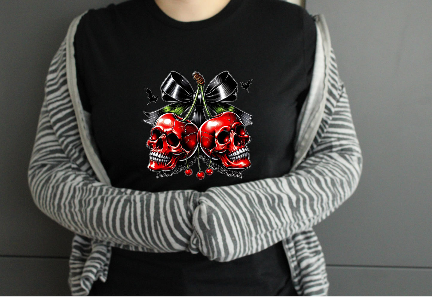 Person wearing a black tshirt with red skull design 