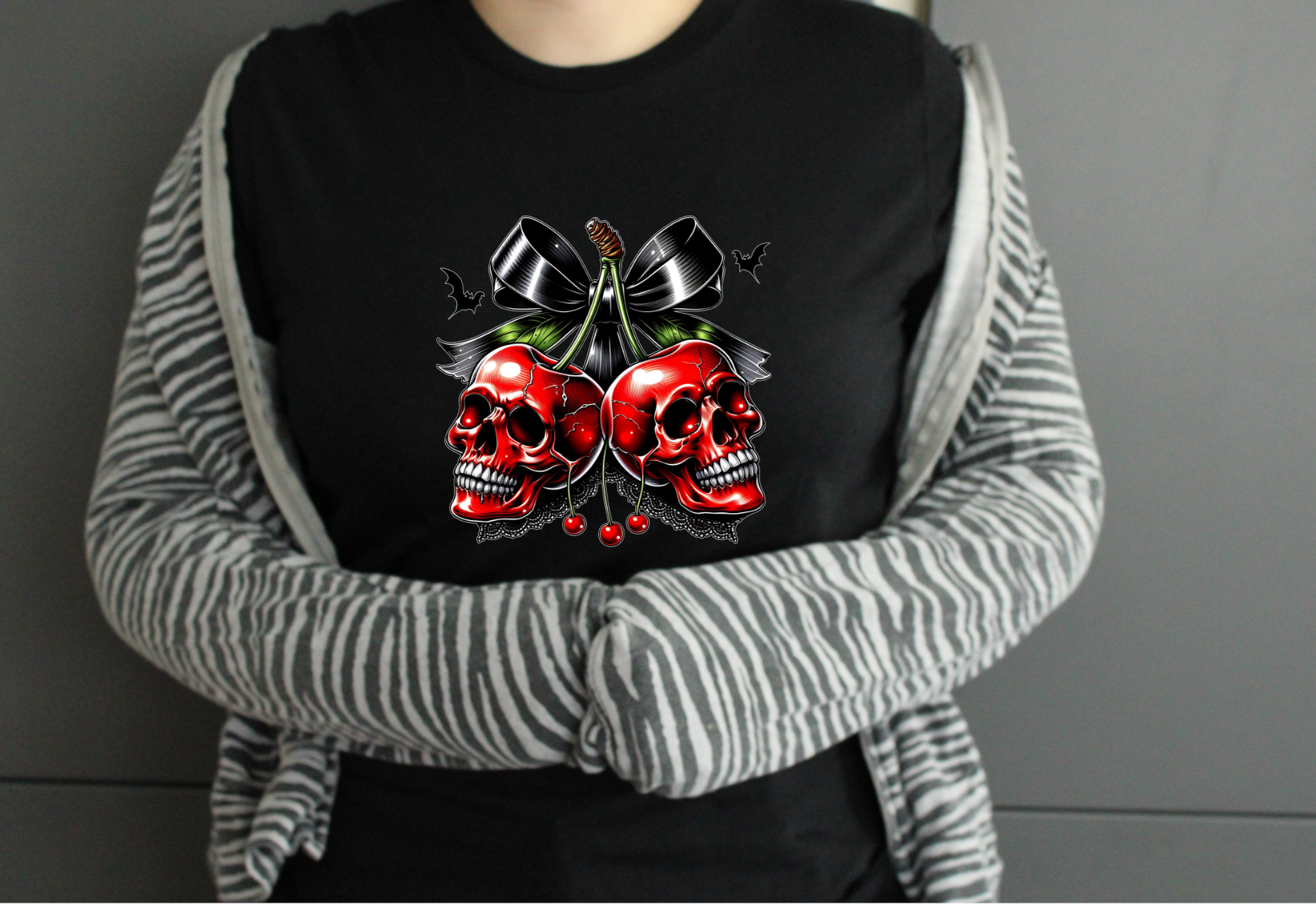 Person wearing a black tshirt with red skull design 