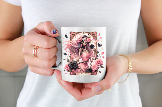 Person holding a mug with a pink and black design on a plain background