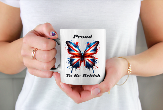 Person holding a mug with a butterfly design and text 'Proud To Be British' against a white background