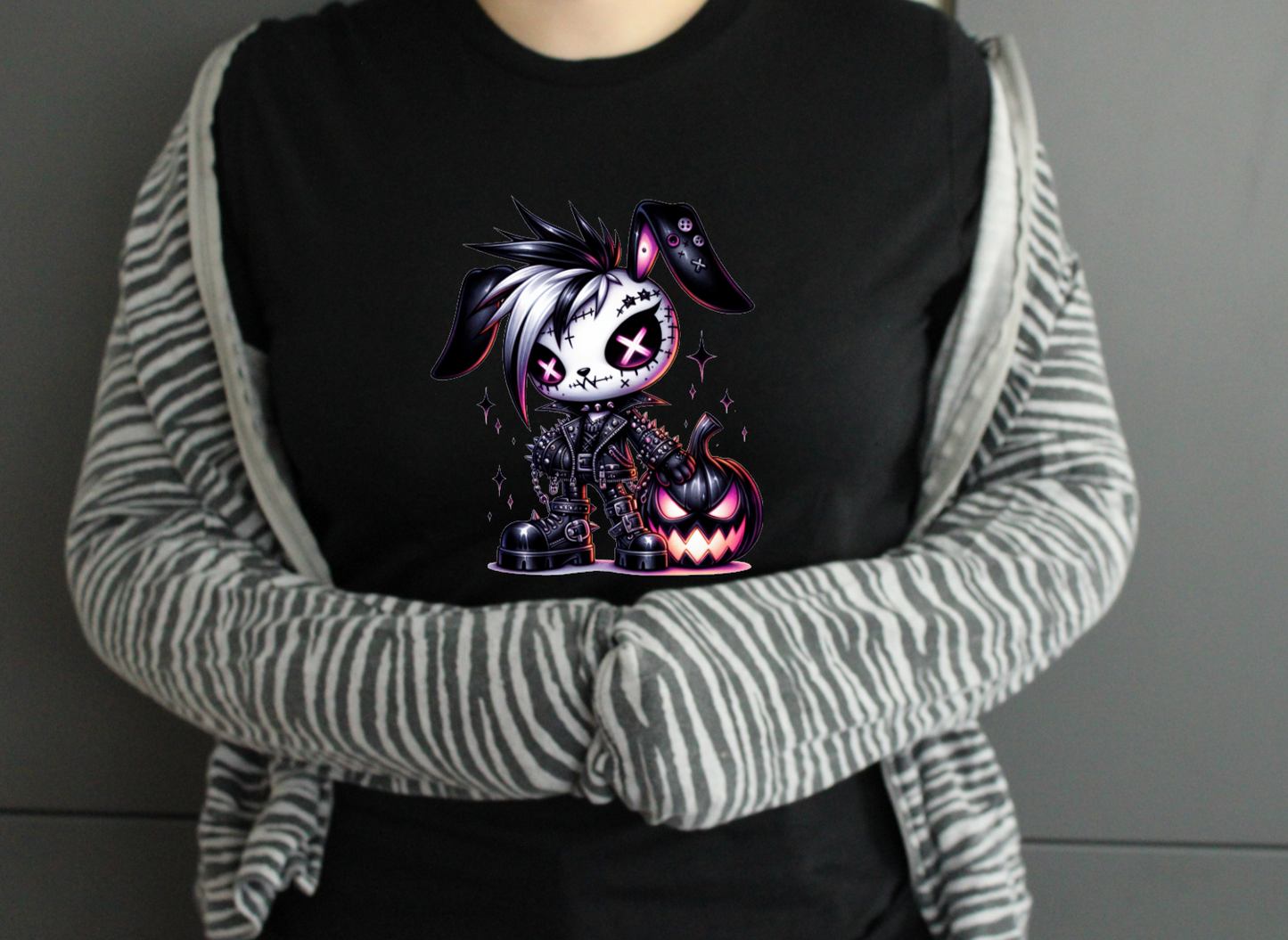 Person wearing a black shirt with a graphic design, 