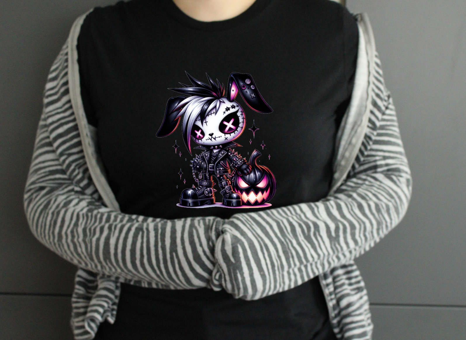 Person wearing a black shirt with a graphic design, 