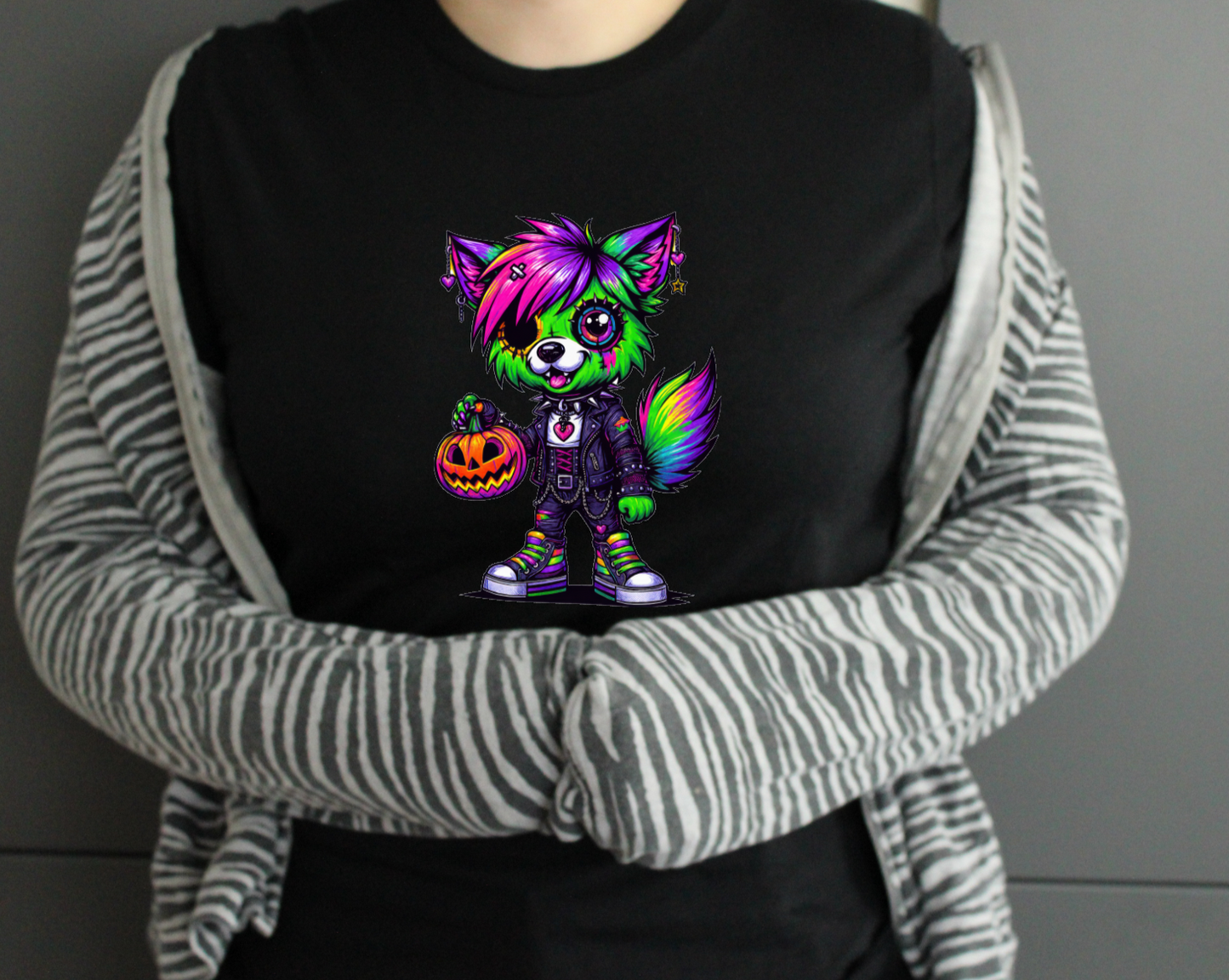Person wearing a black tshirt with a colourful cartoon character design.
