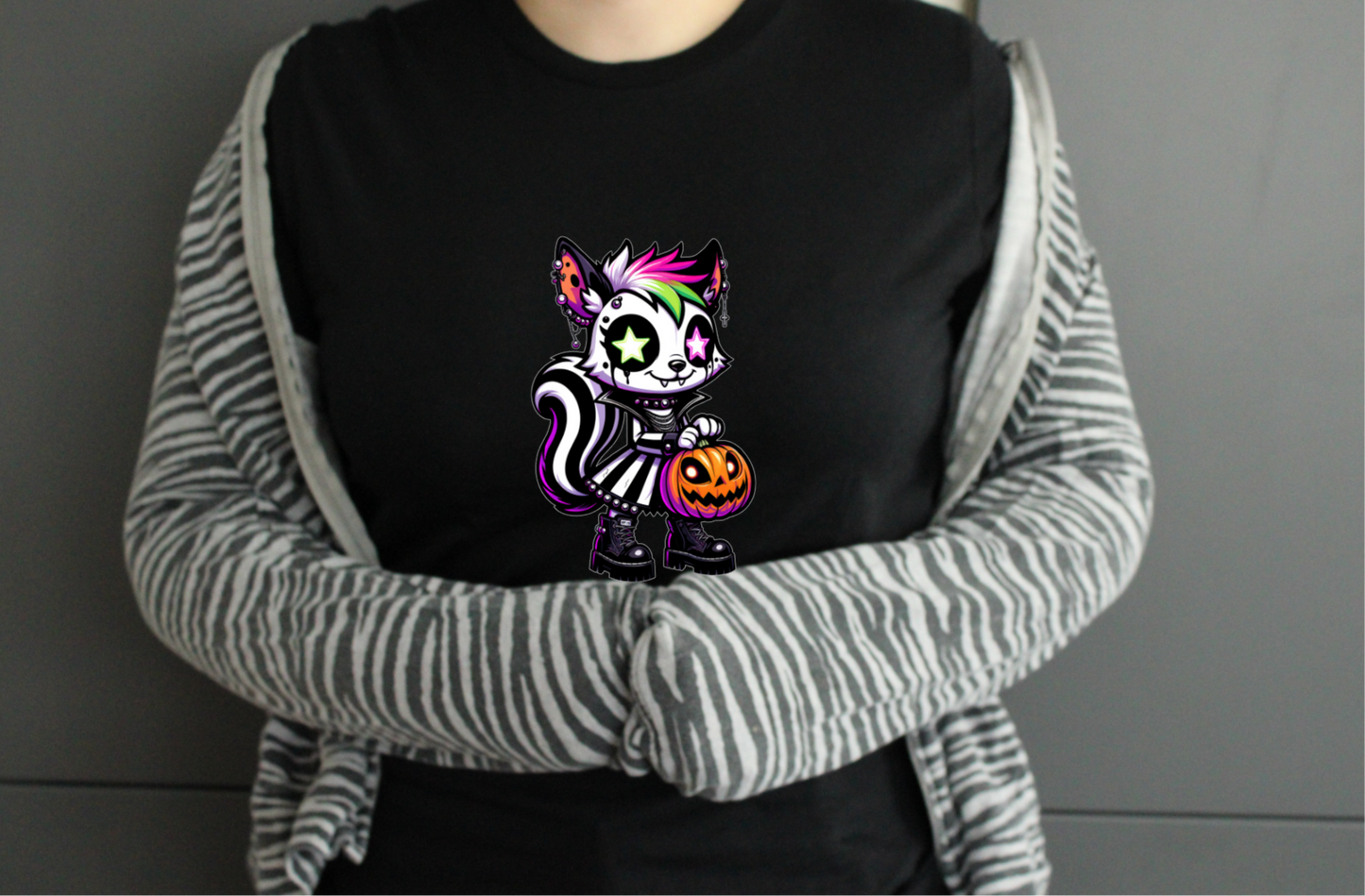 Person wearing a black tshirt with a colorful cat design, 
