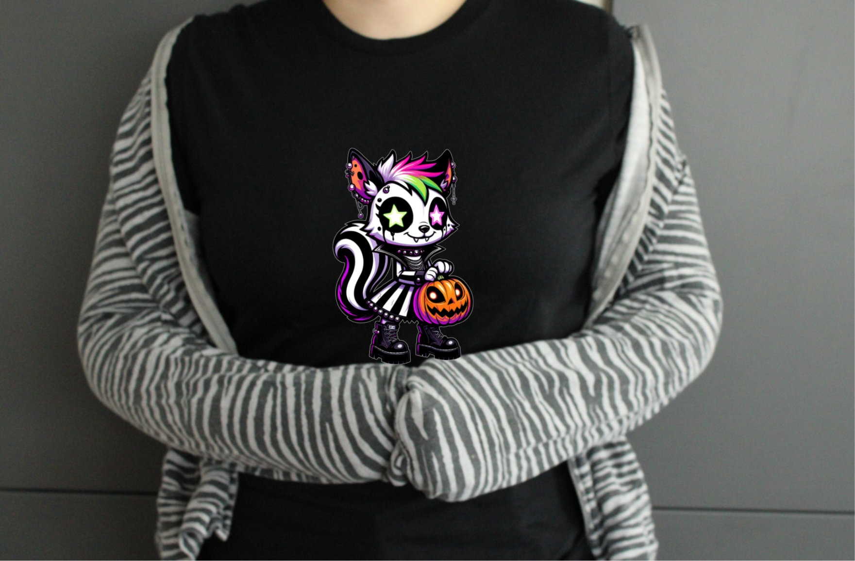 Person wearing a black tshirt with a colorful cat design, 